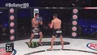 two men are fighting in a boxing ring with the time 3:51