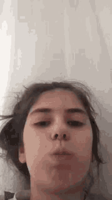 a close up of a woman making a face with her mouth open .