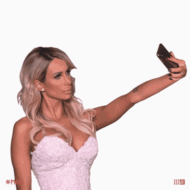 a woman in a white dress taking a selfie