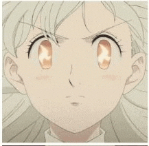 a close up of a girl 's face with a serious look on her face and a flame in her eyes .