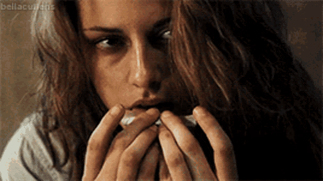 a close up of a woman covering her mouth with her hands with the hashtag bellacurtains visible in the corner