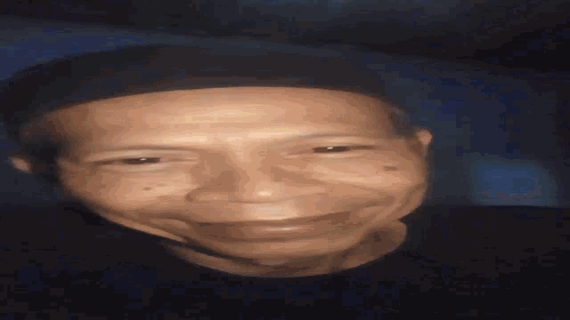 a close up of a man 's face with his eyes closed and a ring on his finger