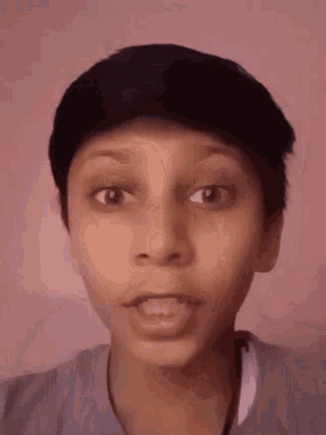 a close up of a person 's face with a surprised look on their face