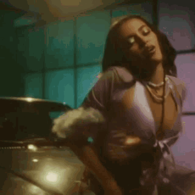 a blurred image of a woman in a purple top