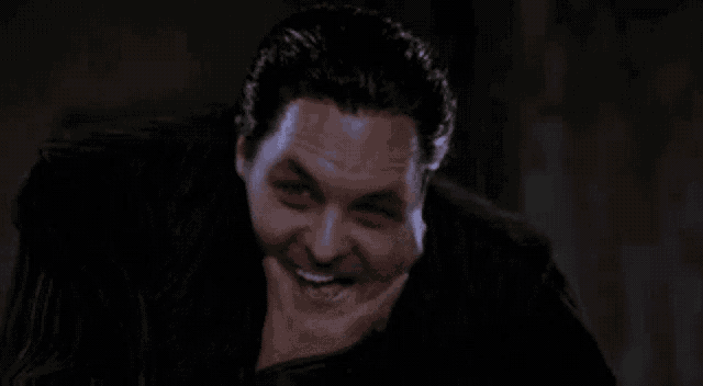 a man is making a funny face with his hand on his face