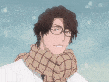 a man wearing glasses and a scarf smiles in the snow