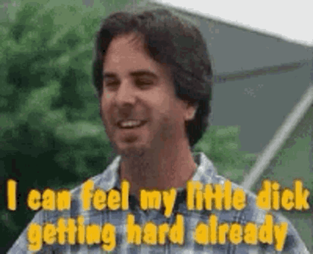 a man in a plaid shirt is smiling and talking about his little dick getting hard already .