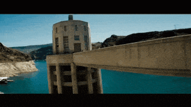 a bridge over a body of water with a building in the foreground