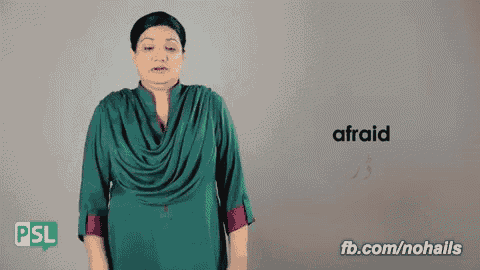 a woman in a green shirt says afraid in a sign language video