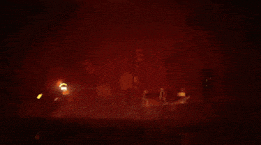 a blurred image of a person holding a light in a dark room
