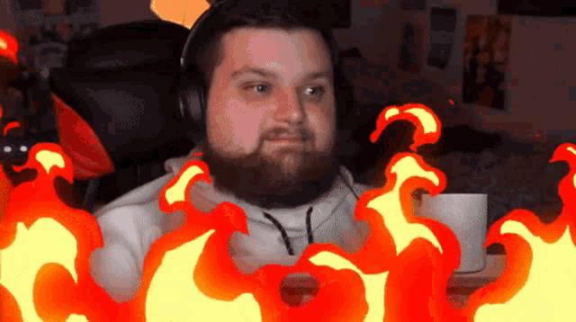 a man with a beard wearing headphones and a white shirt