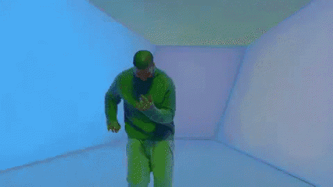 a man is standing in a room with a purple wall and a pink wall .