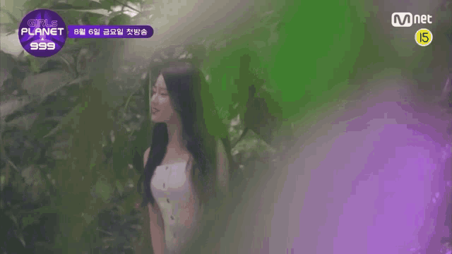 a woman in a white dress is standing in a jungle .