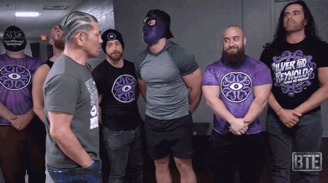 a group of men wearing silver and reynolds t-shirts