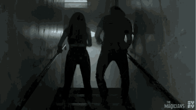 a man and a woman are walking down a set of stairs with the tv show the magicians behind them