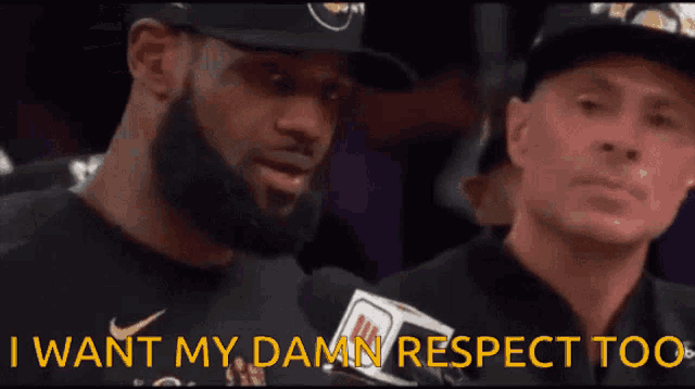 a man with a beard is talking into a microphone and says " i want my damn respect too "