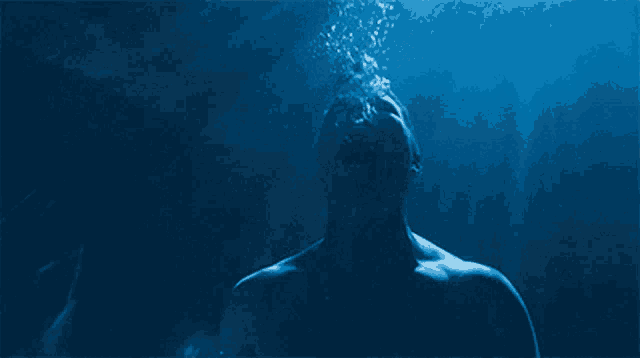 a man is underwater with his mouth open