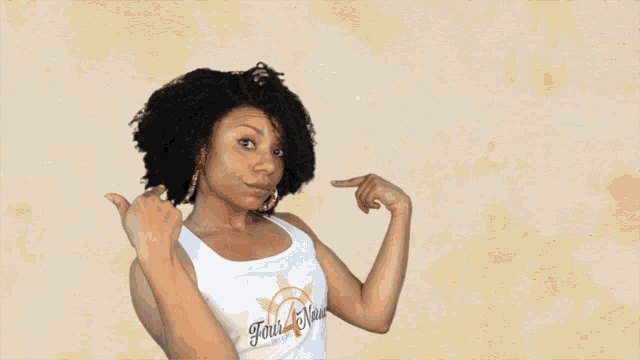 a woman in a white tank top with a sun on it
