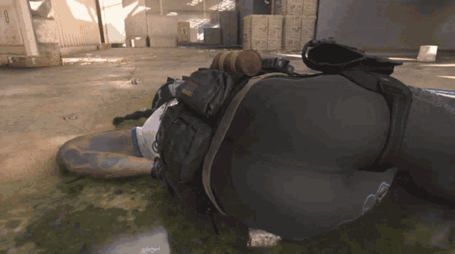 a person is laying on the floor with a backpack that says ' tactical ' on it