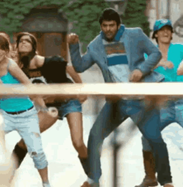a group of people are dancing and one of them is wearing a shirt that says ' abercrombie & fitch '