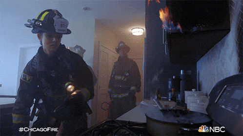 a fireman with the number 81 on his helmet is standing in a kitchen