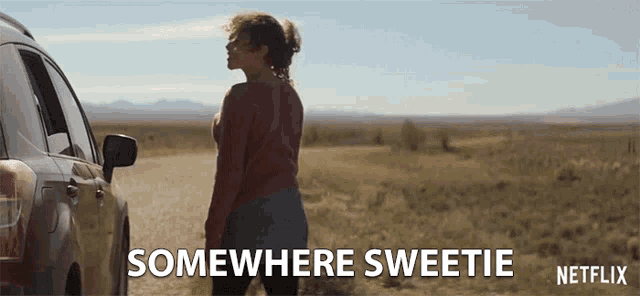 a woman is standing next to a car on a dirt road with the words somewhere sweetie netflix on the bottom