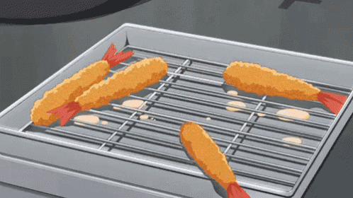 a bunch of fried shrimp are sitting on a grill