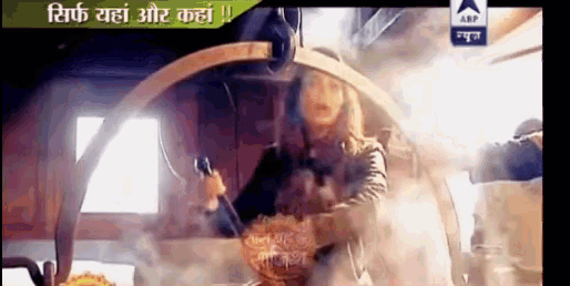 a tv screen shows a woman cooking in a pot with smoke coming out of it and a sign that says arp