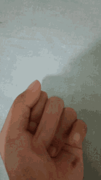 a close up of a person 's hand on a white background
