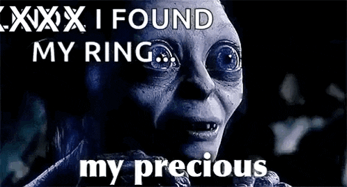 a close up of a person 's face with the words `` i found my ring , my precious '' .