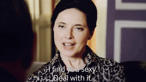 a woman in a leopard print jacket is talking to a man .