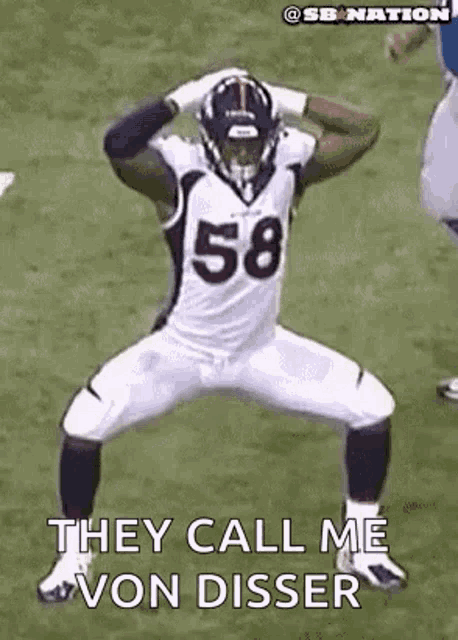 a football player with the number 58 on his jersey is jumping in the air .