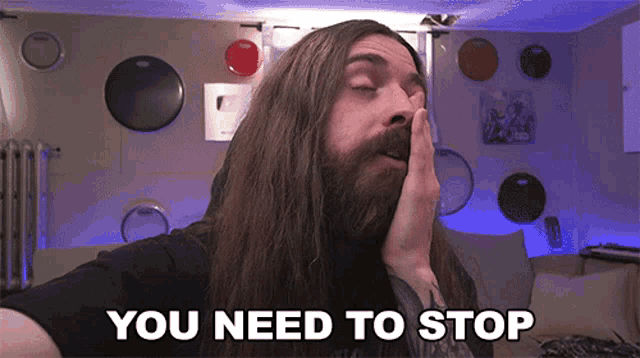 a man with long hair and a beard saying you need to stop