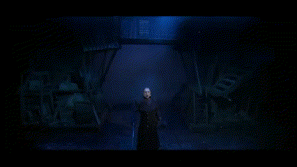 a man holding a sword in a dark room