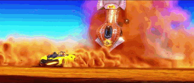 a yellow car is driving down a dirt road in front of a huge explosion