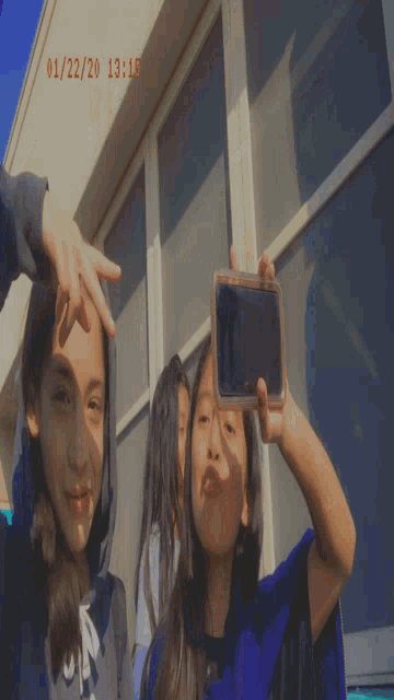 two girls are posing for a picture and the date is 01/12/2020