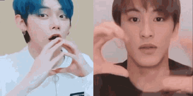 a man with blue hair and a man with brown hair are making a heart shape with their hands .