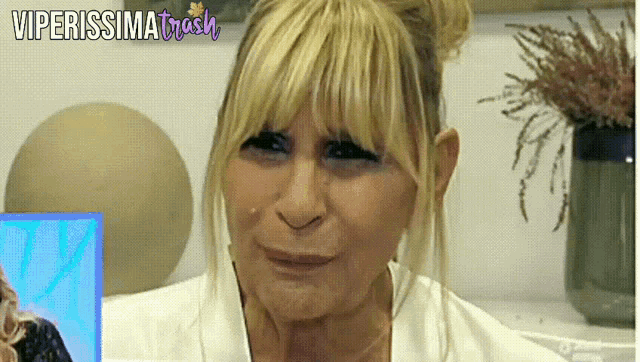 a close up of a woman 's face with the words viperissima trash written above her