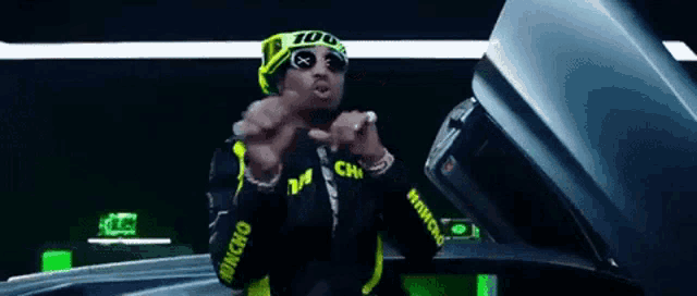 a man wearing sunglasses and a headband that says 100