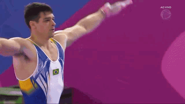 a gymnast with the number 77 on the back of his uniform