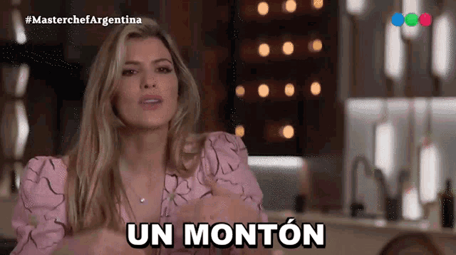 a woman in a pink dress says " un monton " in spanish