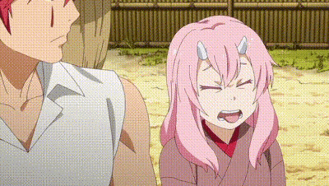 a man and a girl are standing next to each other in a field . the girl is wearing pink hair and horns .