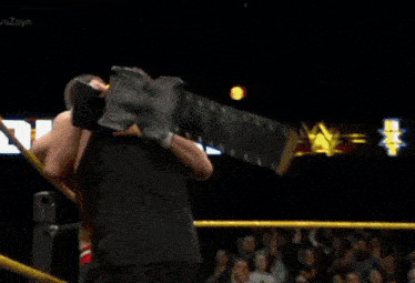 two men wrestling in front of a sign that says ' lon '