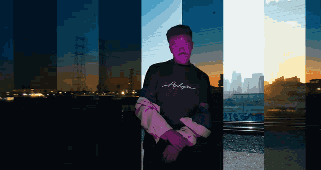 a man wearing a purple shirt that says anderson stands in front of a city skyline