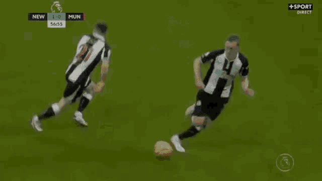two soccer players are playing a game of soccer on a soccer field .