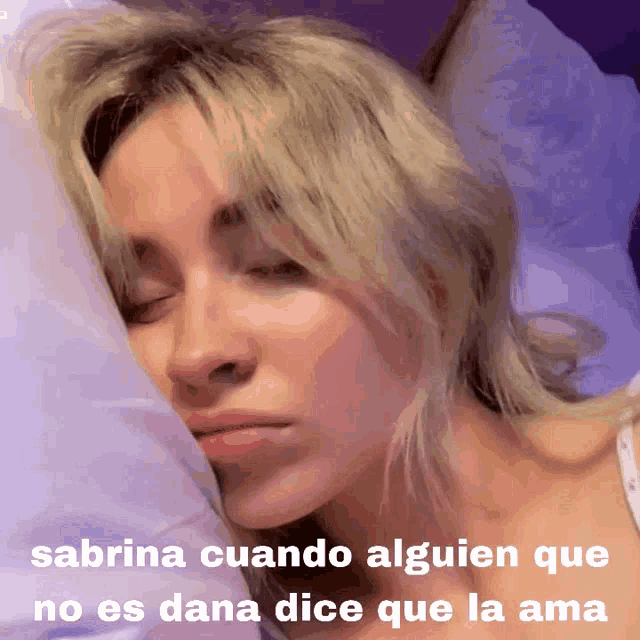 a picture of a woman sleeping with a caption that says sabrina cuando alguen que no es dana dice que la ama