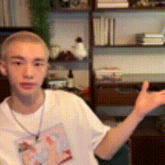 a young man wearing a white t-shirt with a cat on it