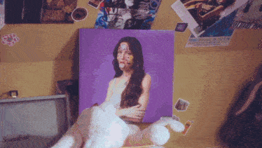 a purple painting of a woman with stickers on her face is on a wall next to a marshall speaker