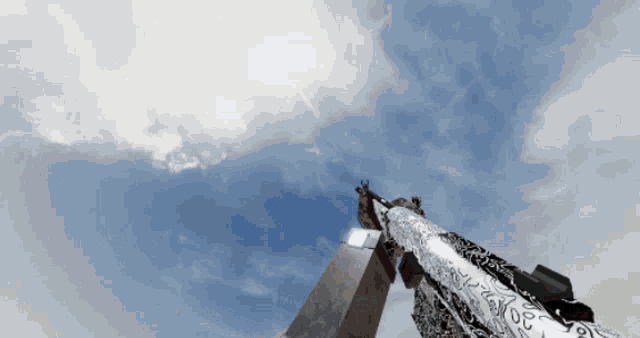 a gun with a pattern on the barrel is pointed up into the sky