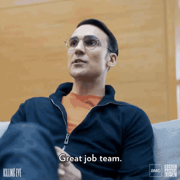 a man sitting on a couch with the words great job team on the bottom